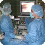 Doctors performing a laparoscopy operation on a woman