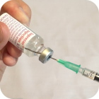  Follicle Stimulating Hormone being drawn from a bottle by a Syringe